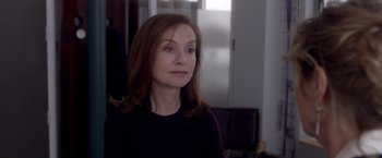 Movie still from “Elle” (2016), directed by Paul Verhoeven – A person with long brown hair; Close Up shot, Over the shoulder angle