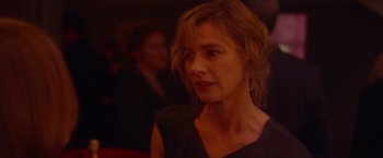 Movie still from “Elle” (2016), directed by Paul Verhoeven – A person wearing a black shirt; Close Up shot, Over the shoulder angle