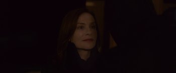 Movie still from “Elle” (2016), directed by Paul Verhoeven – A person wearing a black shirt; Close Up shot, Over the shoulder angle