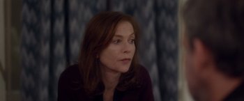 Movie still from “Elle” (2016), directed by Paul Verhoeven – A person sitting in a room; Close Up shot, Over the shoulder angle