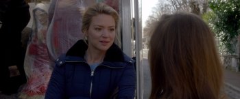 Movie still from “Elle” (2016), directed by Paul Verhoeven – A woman sitting on a bus talking to another woman; Close Up shot, Over the shoulder angle