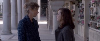 Movie still from “Elle” (2016), directed by Paul Verhoeven – Two women standing next to each other on a sidewalk; Medium shot, Over the shoulder angle