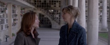 Movie still from “Elle” (2016), directed by Paul Verhoeven – Two women standing next to each other in a building; Close Up shot, Over the shoulder angle