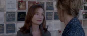 Movie still from “Elle” (2016), directed by Paul Verhoeven – A woman is looking at a man in front of a wall; Close Up shot, Over the shoulder angle