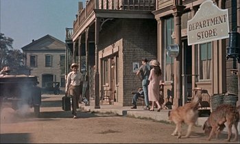 Movie still from “Elmer Gantry” (1960), directed by Richard Brooks – A group of people walking down a sidewalk; Wide shot, Low angle