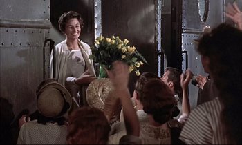 Movie still from “Elmer Gantry” (1960), directed by Richard Brooks – A group of people sitting around a room; Medium shot, Over the shoulder angle