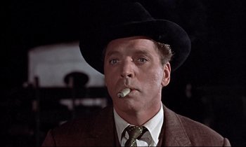 Movie still from “Elmer Gantry” (1960), directed by Richard Brooks – A person wearing a hat and smoking a cigarette; Close Up shot, Low angle