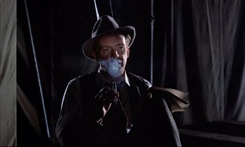 Movie still from “Elmer Gantry” (1960), directed by Richard Brooks – A man wearing a hat and smoking a cigarette; Close Up shot, Low angle