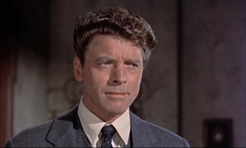 Movie still from “Elmer Gantry” (1960), directed by Richard Brooks – A person wearing a suit and tie; Close Up shot, Low angle
