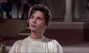 Movie still from “Elmer Gantry” (1960), directed by Richard Brooks – A woman in a white dress looking up at the sky; Close Up shot, Low angle