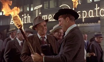 Movie still from “Elmer Gantry” (1960), directed by Richard Brooks – A couple of men standing next to each other; Medium shot, Low angle