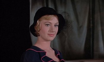 Movie still from “Elmer Gantry” (1960), directed by Richard Brooks – A woman wearing a black hat and a blue dress; Close Up shot, Low angle