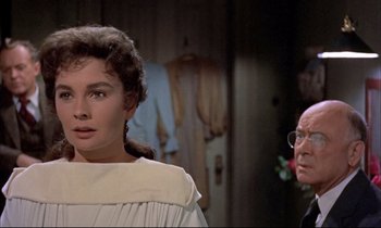 Movie still from “Elmer Gantry” (1960), directed by Richard Brooks – A woman standing next to an older man in front of a door; Close Up shot, Over the shoulder angle