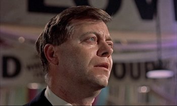 Movie still from “Elmer Gantry” (1960), directed by Richard Brooks – A person wearing a suit and tie; Close Up shot, Low angle