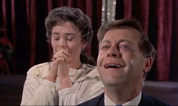 Movie still from “Elmer Gantry” (1960), directed by Richard Brooks – A man and a woman sitting next to each other; Close Up shot, Low angle