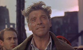 Movie still from “Elmer Gantry” (1960), directed by Richard Brooks – A person wearing a jacket; Close Up shot, Low angle