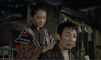 Movie still from “Empire of Passion” (1978), directed by Nagisa Ôshima – A man and a woman in traditional japanese garb; Medium shot, High angle