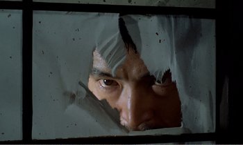 Movie still from “Empire of Passion” (1978), directed by Nagisa Ôshima – A man looking through a hole in a wall; Extreme Close Up shot, Low angle