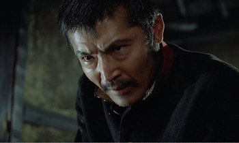 Movie still from “Empire of Passion” (1978), directed by Nagisa Ôshima – A person with a mustache; Close Up shot, Low angle