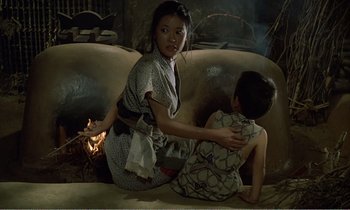 Movie still from “Empire of Passion” (1978), directed by Nagisa Ôshima – A woman sitting on the ground with a child; Medium shot, High angle