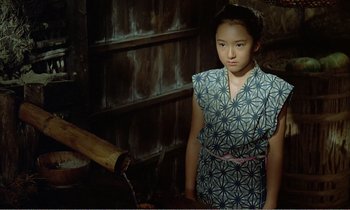 Movie still from “Empire of Passion” (1978), directed by Nagisa Ôshima – A young asian girl in a blue and white dress; Medium shot, High angle