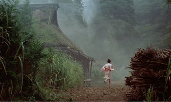 Movie still from “Empire of Passion” (1978), directed by Nagisa Ôshima – A woman running down a dirt road in front of a hut; Extreme Wide shot, High angle