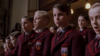 Movie still from “Empire of the Sun” (1987), directed by Steven Spielberg – A group of young boys in school uniforms standing in a row; Close Up shot, Low angle