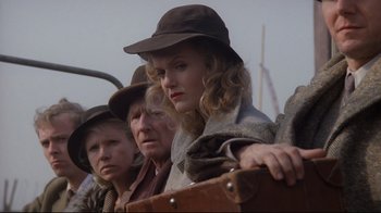 Movie still from “Empire of the Sun” (1987), directed by Steven Spielberg – A group of people standing next to each other wearing hats; Close Up shot, Low angle
