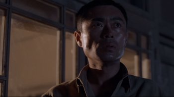 Movie still from “Empire of the Sun” (1987), directed by Steven Spielberg – A person wearing a shirt and tie; Close Up shot, Low angle