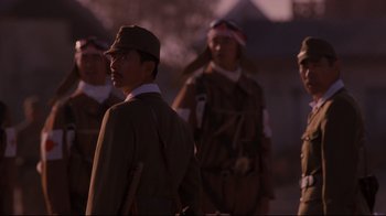 Movie still from “Empire of the Sun” (1987), directed by Steven Spielberg – A group of men in military uniforms standing next to each other; Close Up shot, Low angle