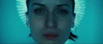 Movie still from “Empire of the Wolves” (2005), directed by Chris Nahon – A woman's face in a dark room; Extreme Close Up shot, Overhead angle