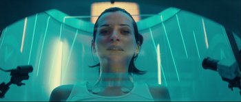 Movie still from “Empire of the Wolves” (2005), directed by Chris Nahon – A woman is standing inside of an enclosure; Close Up shot, Overhead angle