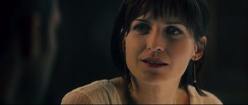 Movie still from “Empire of the Wolves” (2005), directed by Chris Nahon – A woman's face in a dark room; Close Up shot, Over the shoulder angle