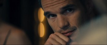 Movie still from “Empire of the Wolves” (2005), directed by Chris Nahon – A man's face with his hand under his chin; Close Up shot, Over the shoulder angle