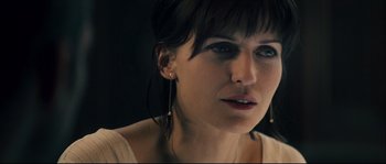 Movie still from “Empire of the Wolves” (2005), directed by Chris Nahon – A person wearing earrings; Close Up shot, Over the shoulder angle