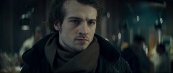 Movie still from “Empire of the Wolves” (2005), directed by Chris Nahon – A person wearing a scarf; Close Up shot, Over the shoulder angle