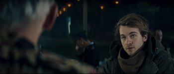 Movie still from “Empire of the Wolves” (2005), directed by Chris Nahon – A man sitting in front of another man in a black jacket; Close Up shot, Over the shoulder angle