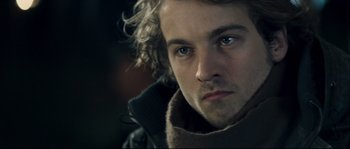 Movie still from “Empire of the Wolves” (2005), directed by Chris Nahon – A person wearing a jacket; Close Up shot, Over the shoulder angle
