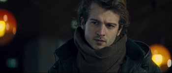 Movie still from “Empire of the Wolves” (2005), directed by Chris Nahon – A person wearing a scarf; Close Up shot, Over the shoulder angle
