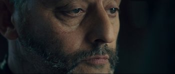 Movie still from “Empire of the Wolves” (2005), directed by Chris Nahon – A man with a beard and mustache; Extreme Close Up shot, Overhead angle