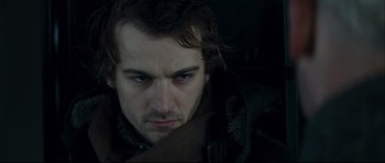 Movie still from “Empire of the Wolves” (2005), directed by Chris Nahon – A person looking at the camera; Close Up shot, Over the shoulder angle