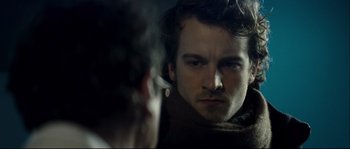 Movie still from “Empire of the Wolves” (2005), directed by Chris Nahon – A man smoking a cigarette in front of a mirror; Close Up shot, Over the shoulder angle