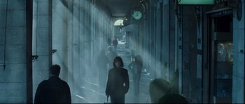 Movie still from “Empire of the Wolves” (2005), directed by Chris Nahon – People walking down a street in the fog; Wide shot, Low angle
