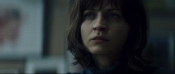 Movie still from “Empire of the Wolves” (2005), directed by Chris Nahon – A person looking at the camera; Close Up shot, Low angle