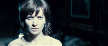 Movie still from “Empire of the Wolves” (2005), directed by Chris Nahon – A person wearing a white shirt; Close Up shot, Over the shoulder angle