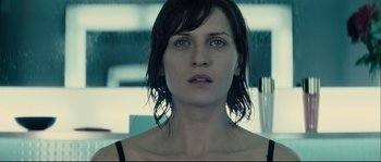 Movie still from “Empire of the Wolves” (2005), directed by Chris Nahon – A person with wet hair; Close Up shot, Over the shoulder angle