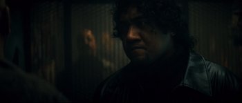 Movie still from “Empire of the Wolves” (2005), directed by Chris Nahon – A person wearing a black jacket; Close Up shot, Over the shoulder angle