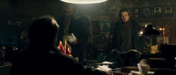 Movie still from “Empire of the Wolves” (2005), directed by Chris Nahon – A man and a woman are standing in front of a mirror; Medium shot, Over the shoulder angle