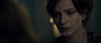 Movie still from “Empire of the Wolves” (2005), directed by Chris Nahon – A person with short brown hair; Close Up shot, Over the shoulder angle