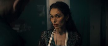 Movie still from “Empire of the Wolves” (2005), directed by Chris Nahon – A woman with a measuring tape around her neck; Close Up shot, Over the shoulder angle